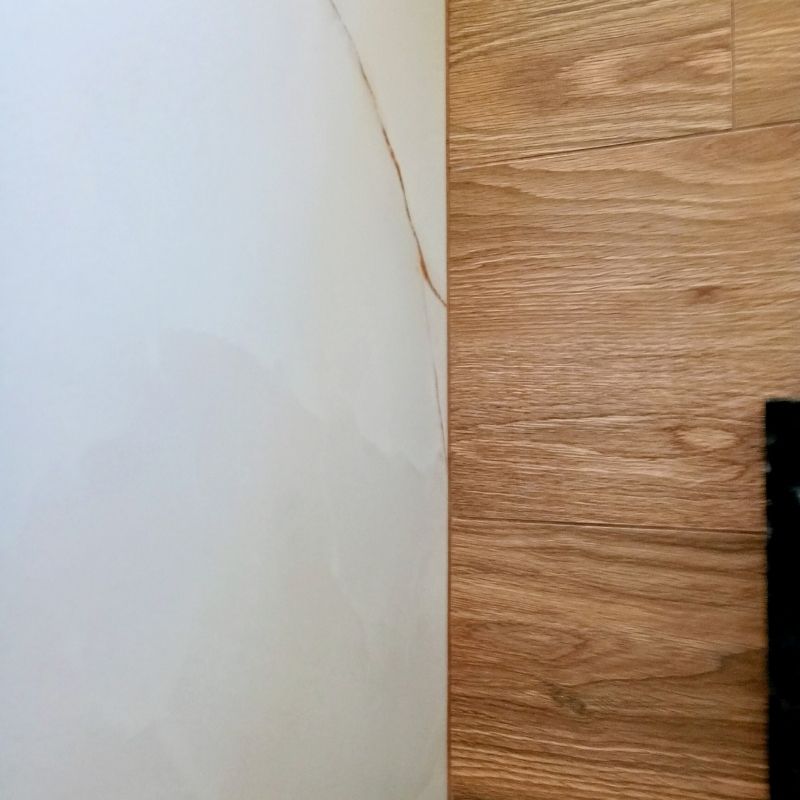 Encontro técnico perfeito em 90 graus entre porcelanato marmorizado e amadeirado